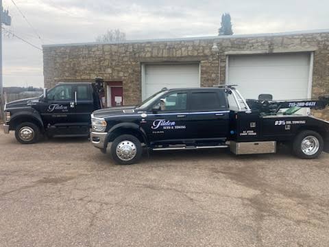 Two Tilden Auto & Towing wreckers parked at the Chippewa Falls shop